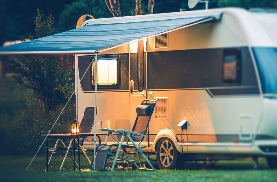 Trailer with extended canopy and two chairs underneath