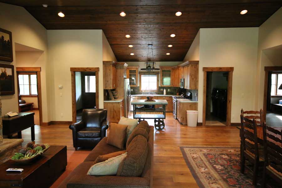 Bunkhouse accommodations living area with kitchen in background