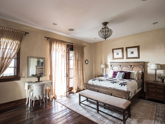 Angle shot of queen bed with desk and chair